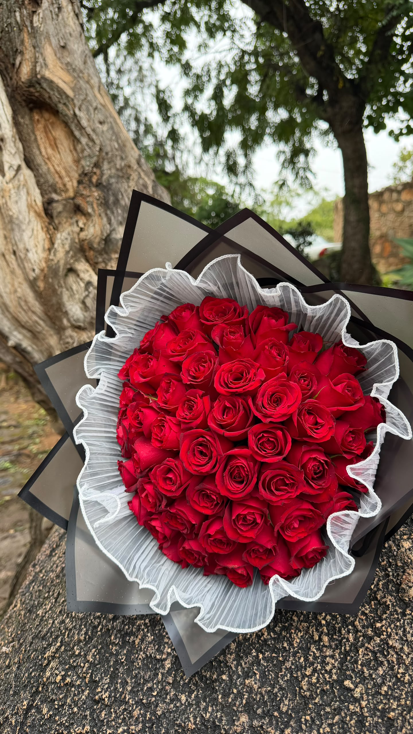 A hand-tied RoseyRose bouquet of fresh roses wrapped in premium paper